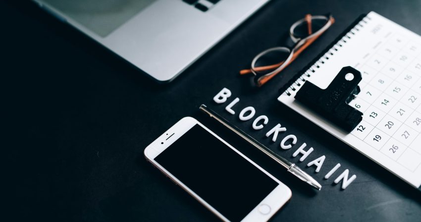 Free Flat lay of a modern digital workspace with blockchain theme, featuring a smartphone and calendar. Stock Photo